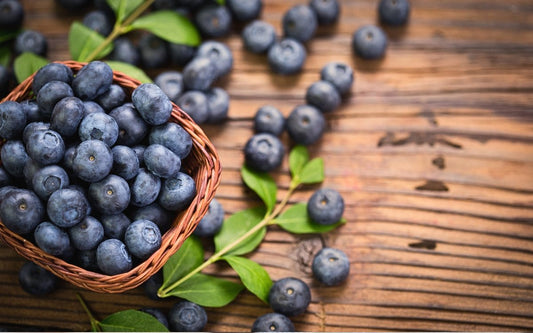 Blaubeeren in einem Körbchen auf einem Holztisch