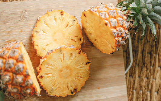 Aufgeschnittene Ananas auf einem Holzbrett